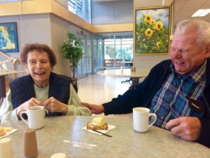 Two senior citizens having a good laugh at Heidi's Haven Assisted Living Facility