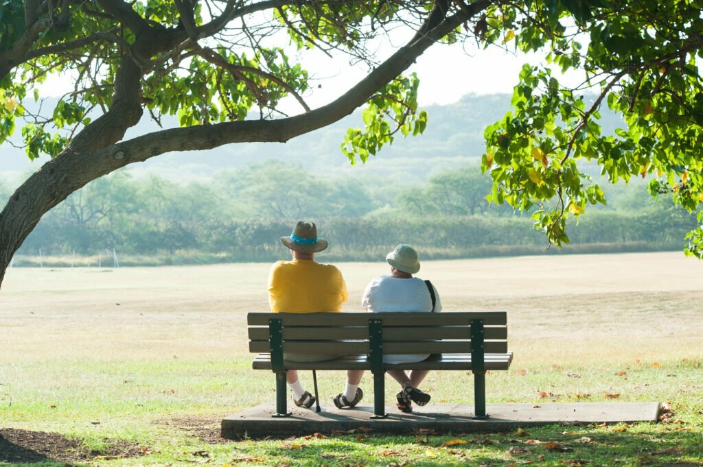 Elderly Couple sitting on a bench in a park